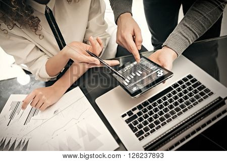 Investment department working process.Photo man showing reports modern tablet screen.Statistics graphics screen.Private banker manager holding pen for signs documents. New business project startup