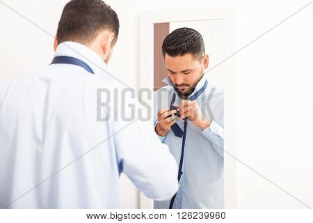 Young Man Getting Dressed And Putting On A Tie