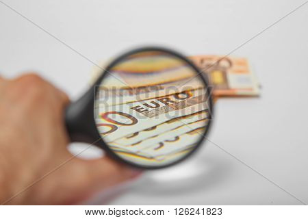 Magnifying Glass on the fifty Euros on isolated background