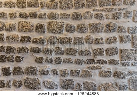 Horizontal stone wall texture close up. Lacquered.