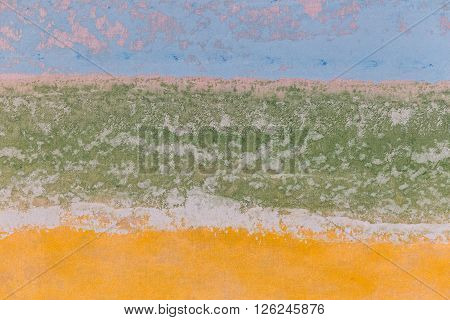 Fragment of canvas texture painted yellow blue green tones. Close-up.