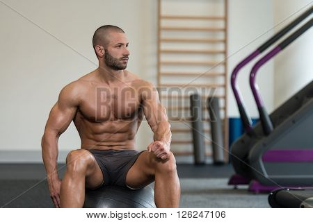 Young Muscular Men Resting After Exercises