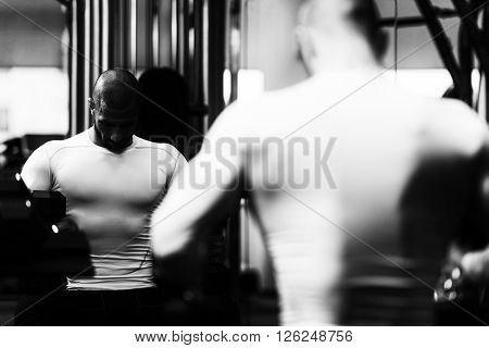 Young Man Resting In Healthy Club After Exercising
