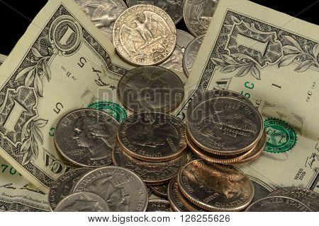 Savings thrift poverty taxes riches couch cushion money dollars dimes nickels and quarters