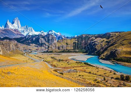 Amazing Patagonia. The white top of Fitzroy rocks covered the midday sun. The drying-up river in the valley of town of El Chalten