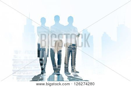 business, teamwork and people concept - business people silhouettes over city background with double exposure effect