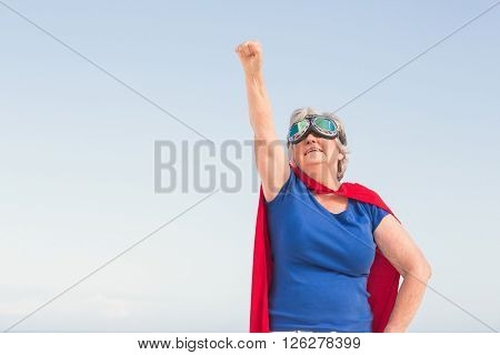 Senior woman wearing superwoman costume on a sunny day