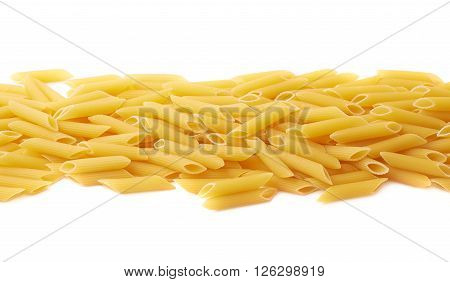 Pile of dried yellow penne pasta lined up in a row, composition isolated over the white background