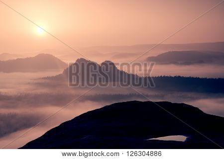 Dreamy Misty Landscape. Majestic Mountain Cut The Lighting Mist. Deep Valley Is Full Of Colorful Fog
