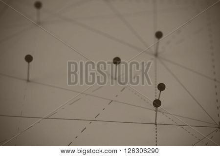 Black Pins In Paper Linked By Lines