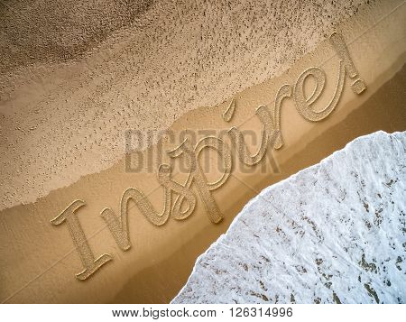 Inspire written on the beach