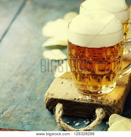 Beer and Potato Chips on vintage wooden table