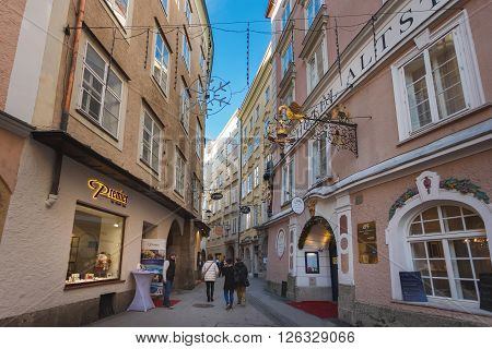 Salzburg Austria - January 07 2016: People walking on the Jew's lane nearby the Alstadt Hotel medieval part of Salzburg
