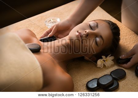 Massage with hot basalt stones. Beautiful deep charming light.