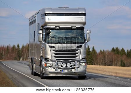 KOSKI TL, FINLAND - APRIL 16, 2016: New modern silver Scania horsebox for horse transport on the road at spring.