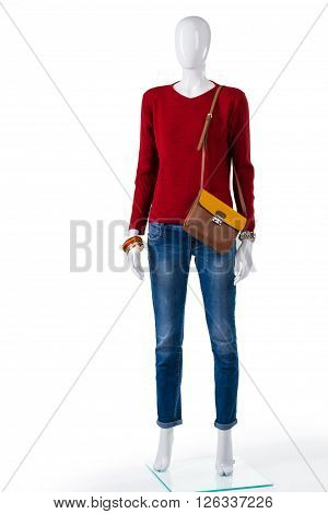 Skinny jeans and red sweater. Mannequin wearing pullover with jeans. Idea for woman's autumn outfit. Trendy clothing in local boutique.