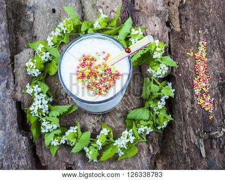 milk shake a caramel color,on the background of spring flowers.
