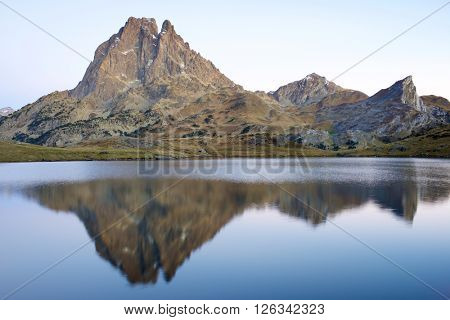 Midi Dossau Peak reflected in Ayous lake. Ossau Valley, Pyrenees National Park, Pyrenees, France.