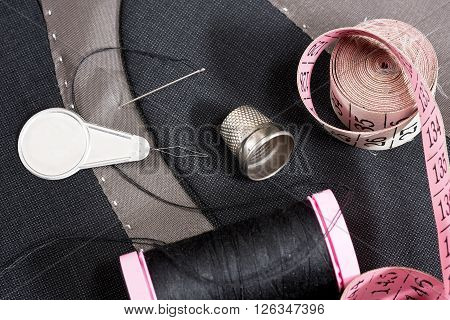 sewing kit on the gray mans jacket