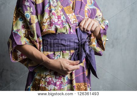 Onsen series : Unrecognizable woman tie obi yukata