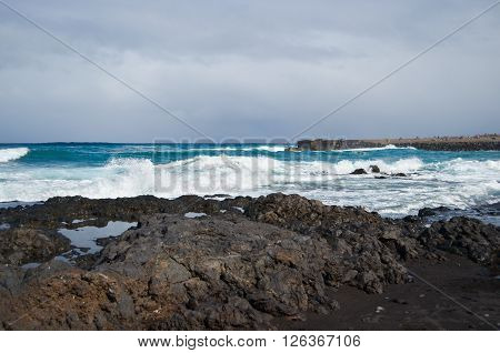 Waves smashing on black rocks in tenerife