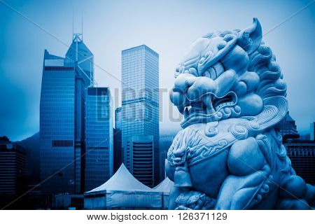 closed-up view of stone lion,shanghai famous skyscrapers,blue stoned image.