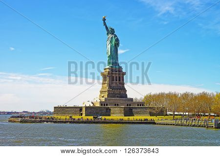View on the Statue on Liberty Island USA in Upper New York Bay. Tourists nearby