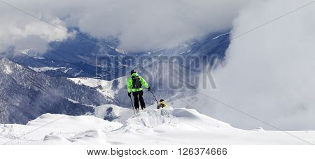 Freeriders On Off-piste Slope And Mountains In Mist