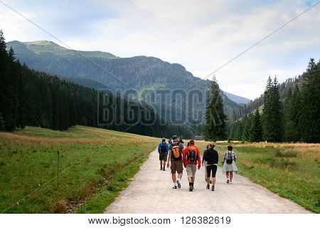 Tatra National Park near Zakopane Poland - August 15 2011: Tourists go on the hiking trail on the Koscieliska Valley in Tatra Moutains.