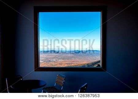 BETANCURIA, FUERTEVENTURA ISLAND, SPAIN - CIRCA JANUARY 2016: Tourists enjoy great view on the central part of Fuerteventura island near Betancuria village from the cafe at Morro Velosa viewpoint