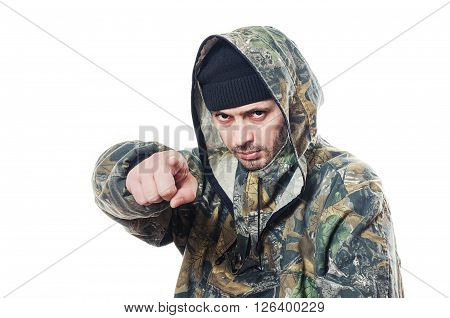 The serious man in a camouflage points a finger forward