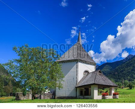 View to church in Dolomite mountains. Italian Alps. Panorama