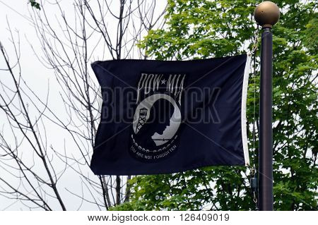 ELWOOD, ILLINOIS / UNITED STATES - MAY 30, 2015: A black POW/MIA Flag flies at the Abraham Lincoln National Cemetery in Elwood, Illinois.