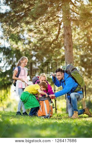 hiker family mountaineering in forest
