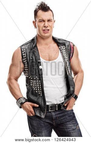 Vertical shot of a displeased punker with an old leather jacket with pins isolated on white background