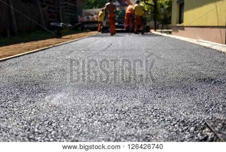 Team Of Workers Making And Constructing Asphalt Road Construction.