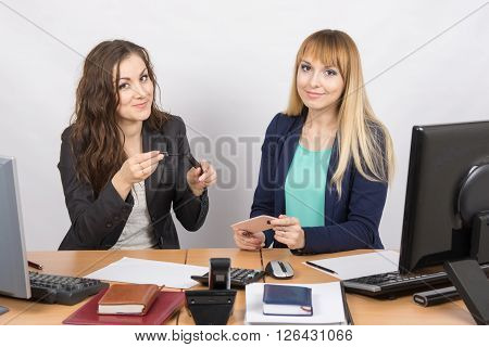 Office Worker Shows A Colleague Mascara At Your Desk