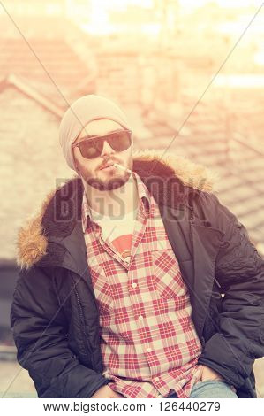 Young handsome urban guy smoking a cigarette.