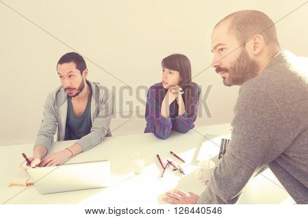 Young group of people/architects discussing business plans.