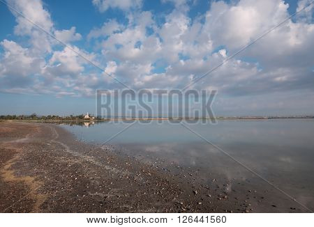 Wonderful morning landscape. The mosque on the edge of the salt lake quiet sunny morning. Wide angle.