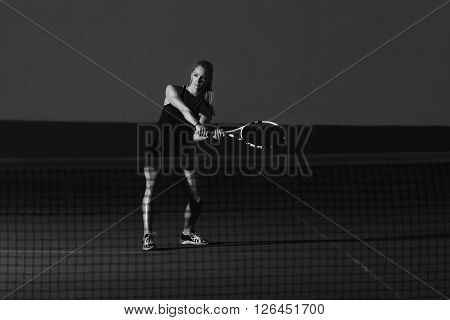 Young Tennis Player Hitting A Ball