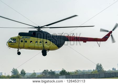 Tyumen, Russia - August 11, 2012: On a visit at UTair airshow in Plehanovo heliport. Passenger helicopter MI-8 landing