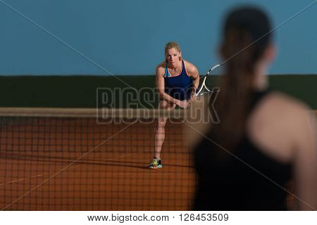 Two Sporty Female Tennis Players Enjoying A Game