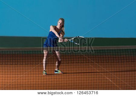Young Girl Playing Tennis Hitting Ball