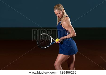 Woman In Sportswear Serves Tennis Ball