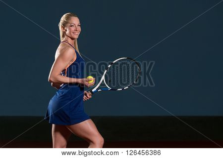 Woman In Sportswear Serves Tennis Ball