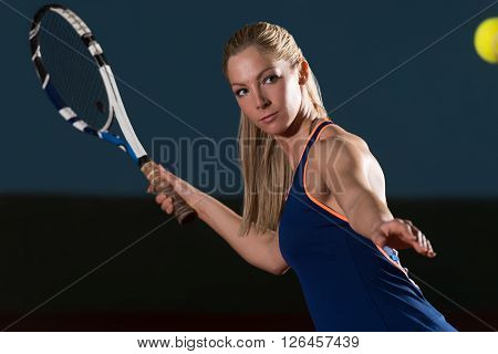 Tennis Player Hitting Tennis Ball