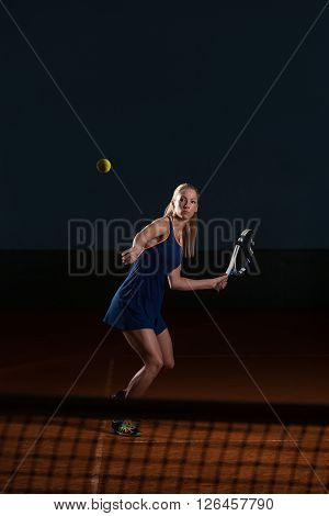 Tennis Player Hitting Tennis Ball