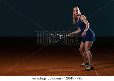 Young Girl Playing Tennis Hitting Ball