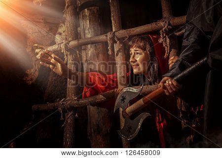 Beautiful Witch In Red Dress In The Dungeon Is Looking On The Sunray.